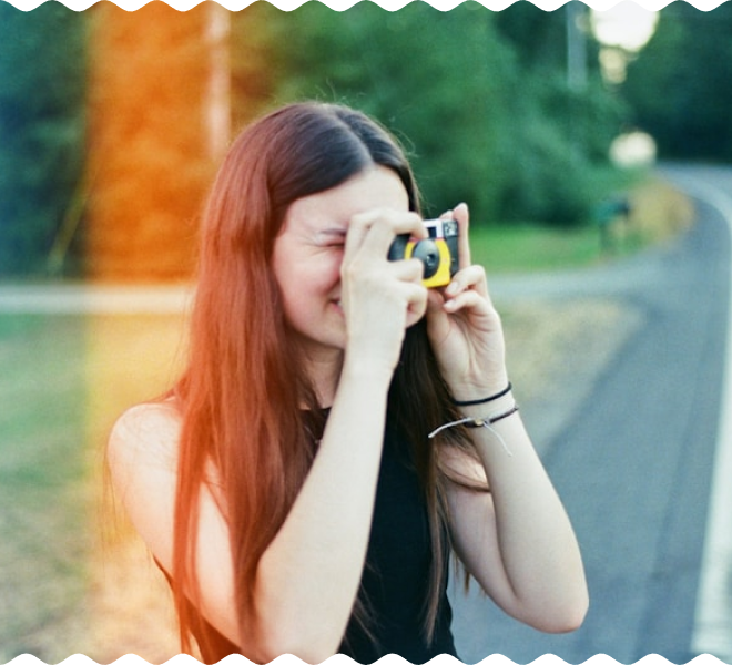 Woman taking a photo with a yellow camera