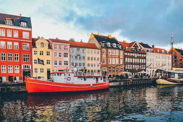 Colorful harbor houses and a red boat in Copenhagen